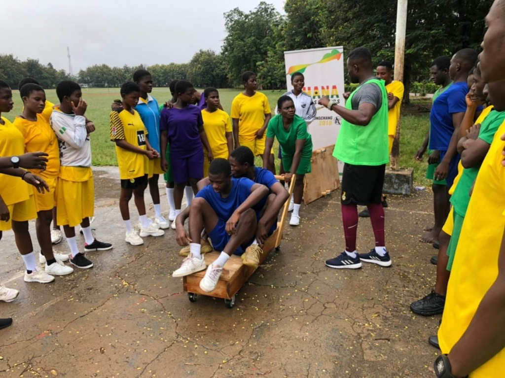 Akwasi Frimpong coaching a group of young African athletes