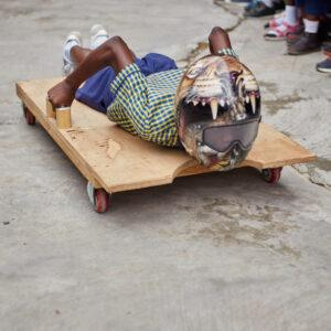 a child with a helmet on a makeshift skeleton board