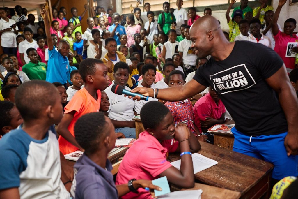 Akwasi Frimpong surrounded by children