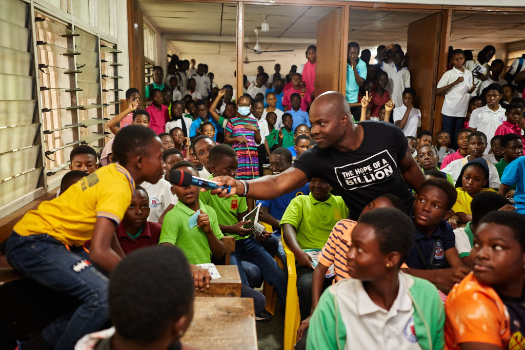 Akwasi Frimpong talking to a child