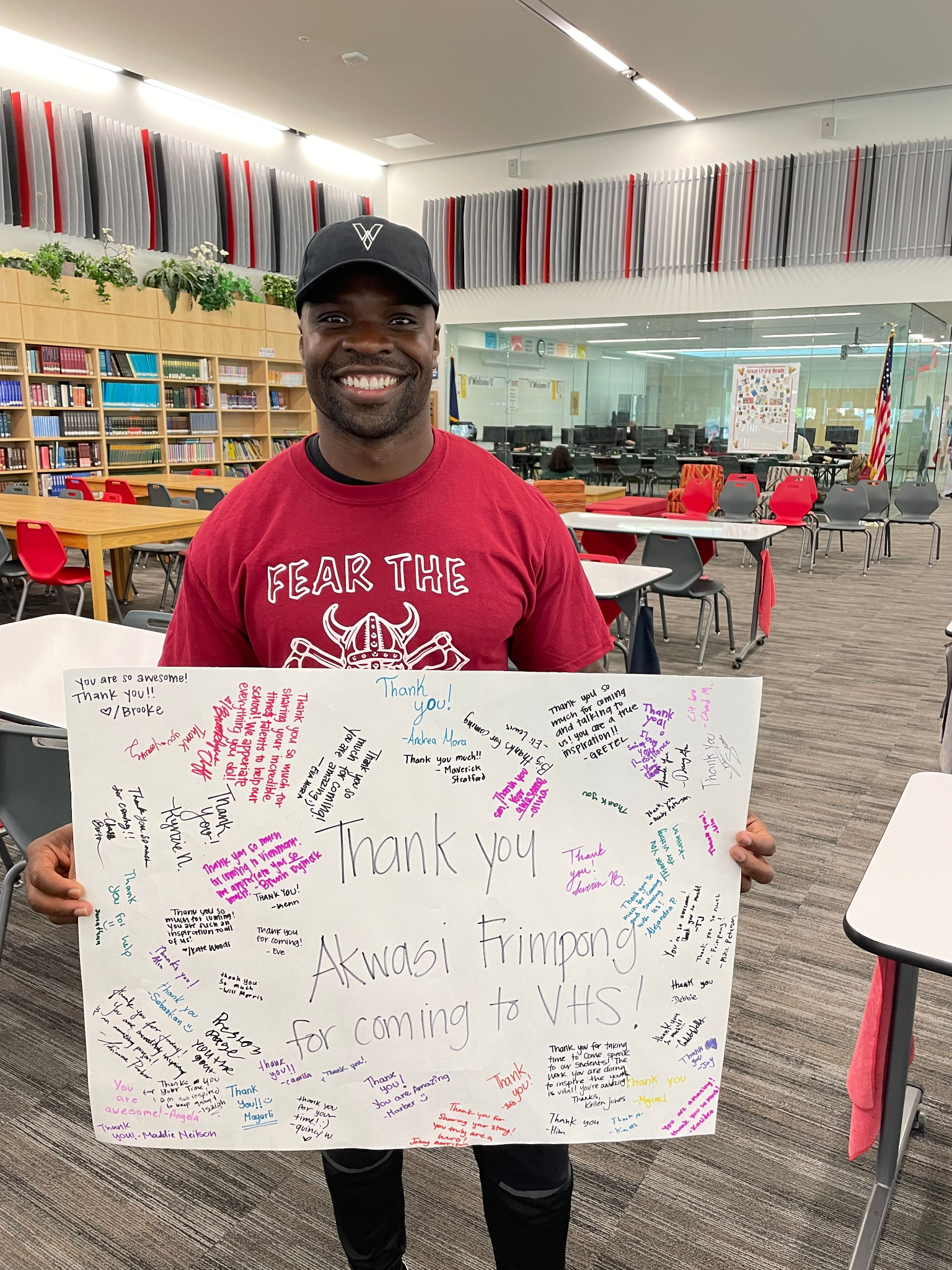 Akwasi Frimpong holds a sign.
