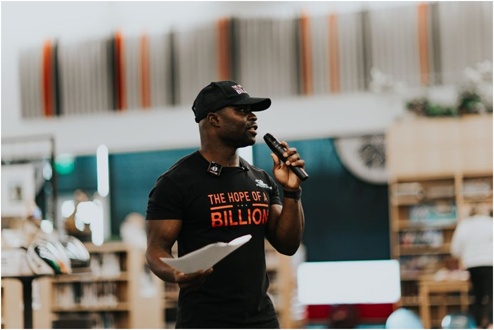 a focused shot of a man speaking into a microphone