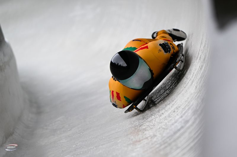 A skeleton athlete sledding