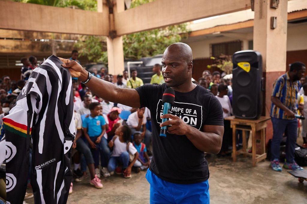 Akwasi Frimpong giving a speech at an HOAB schools program in August 2024 in Ghana