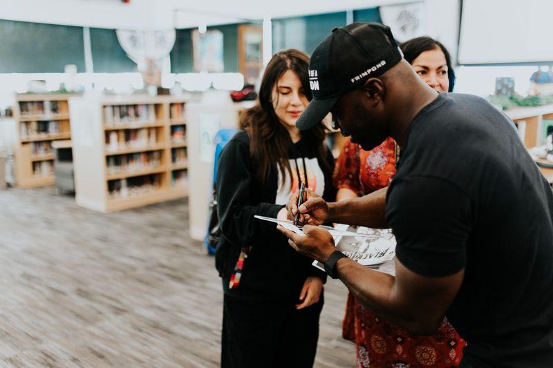 Akwasi Frimpong signing an autograph