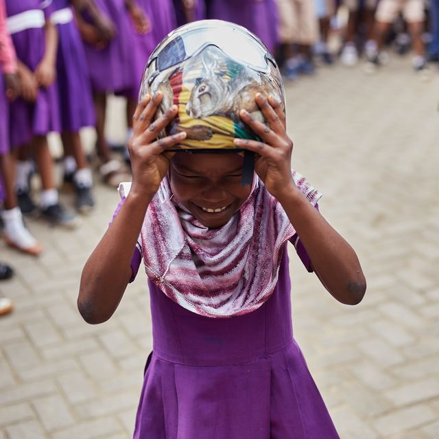 A child wearing Akwasi Frimpong’s helmet