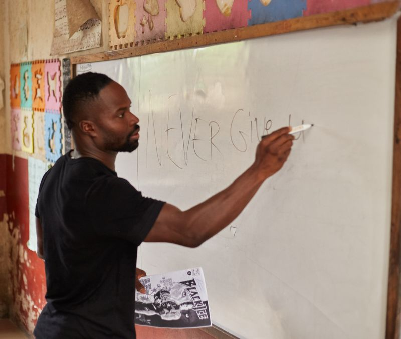 Akwasi Frimpong writing on a board