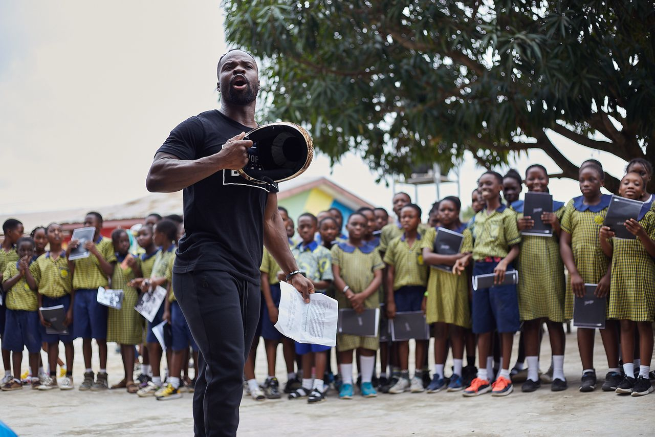 Akwasi Frimpong with a group of kids
