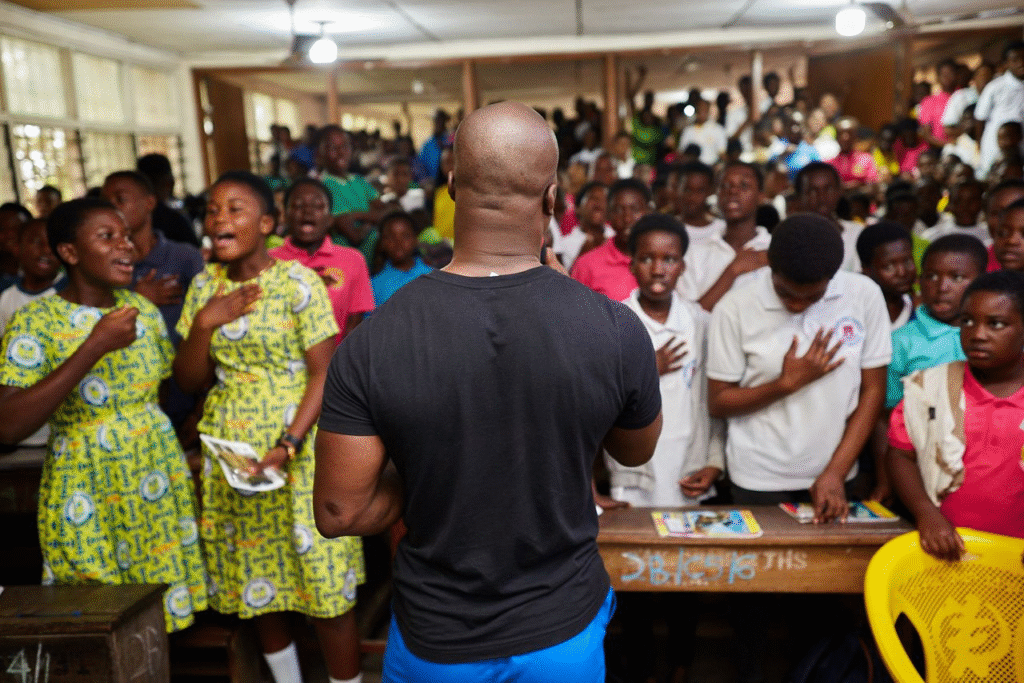 Akwasi Frimpong addressing an audience of kids
