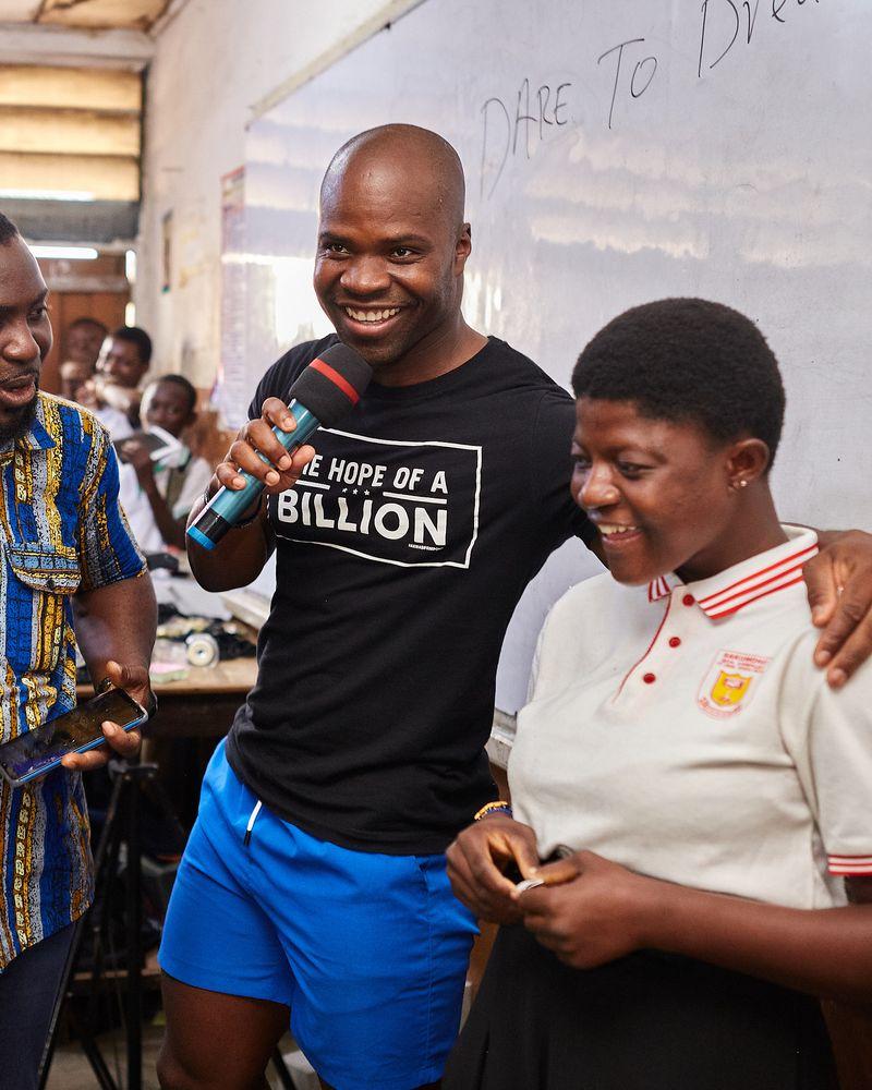 Akwasi Frimpong posing with a child