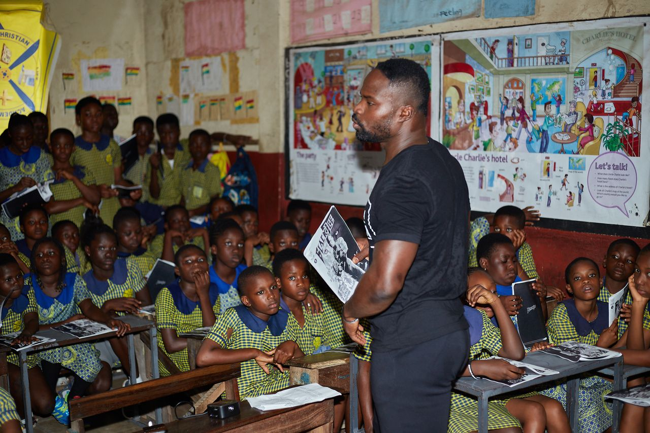 Akwasi Frimpong talking to a class of kids 
