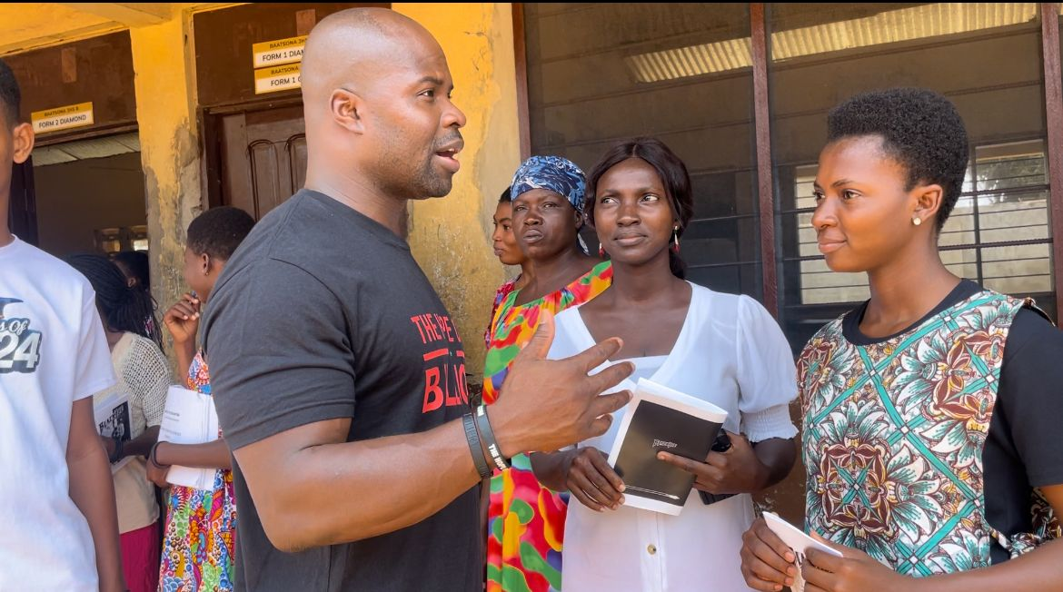 Akwasi Frimpong speaking with community members during a Hope Of A Billion outreach program.